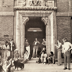 Photo shows people standing around the entrance to the Woman's Building during the opening celebration.