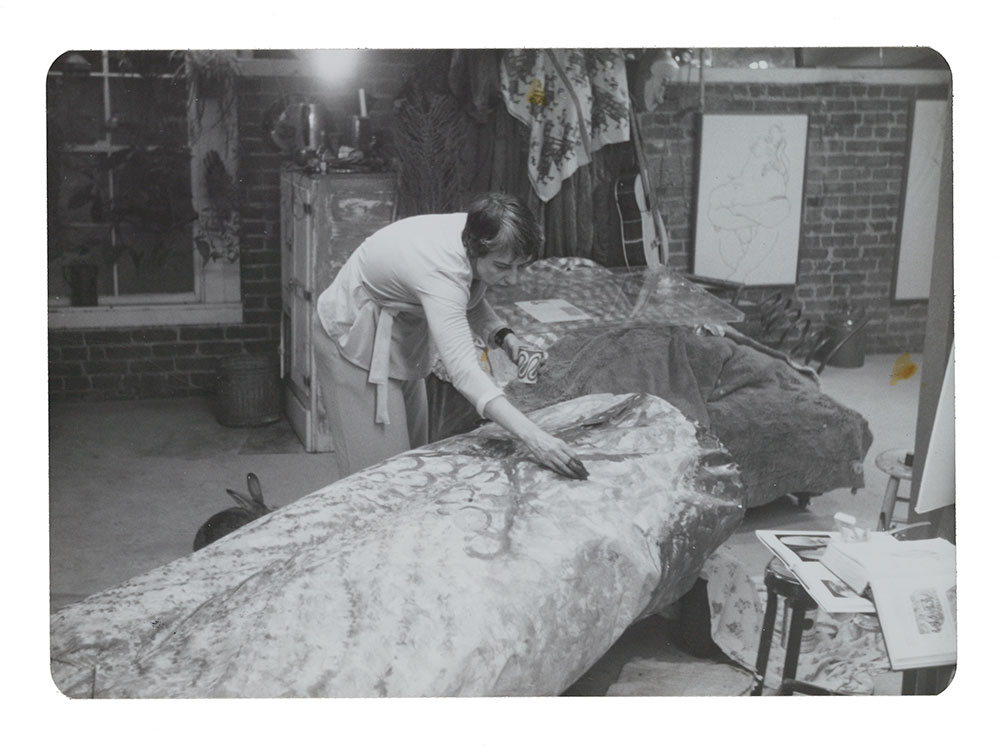 Photograph of Eleanor Dickinson painting her Artists' Soap Box Derby car, Tongue-tied, 1975 / unidentified photographer. Eleanor Dickinson papers, 1951-2003. Archives of American Art, Smithsonian Institution. Image of Eleanor Dickinson painting her car for the Artists' Soap Box Derby