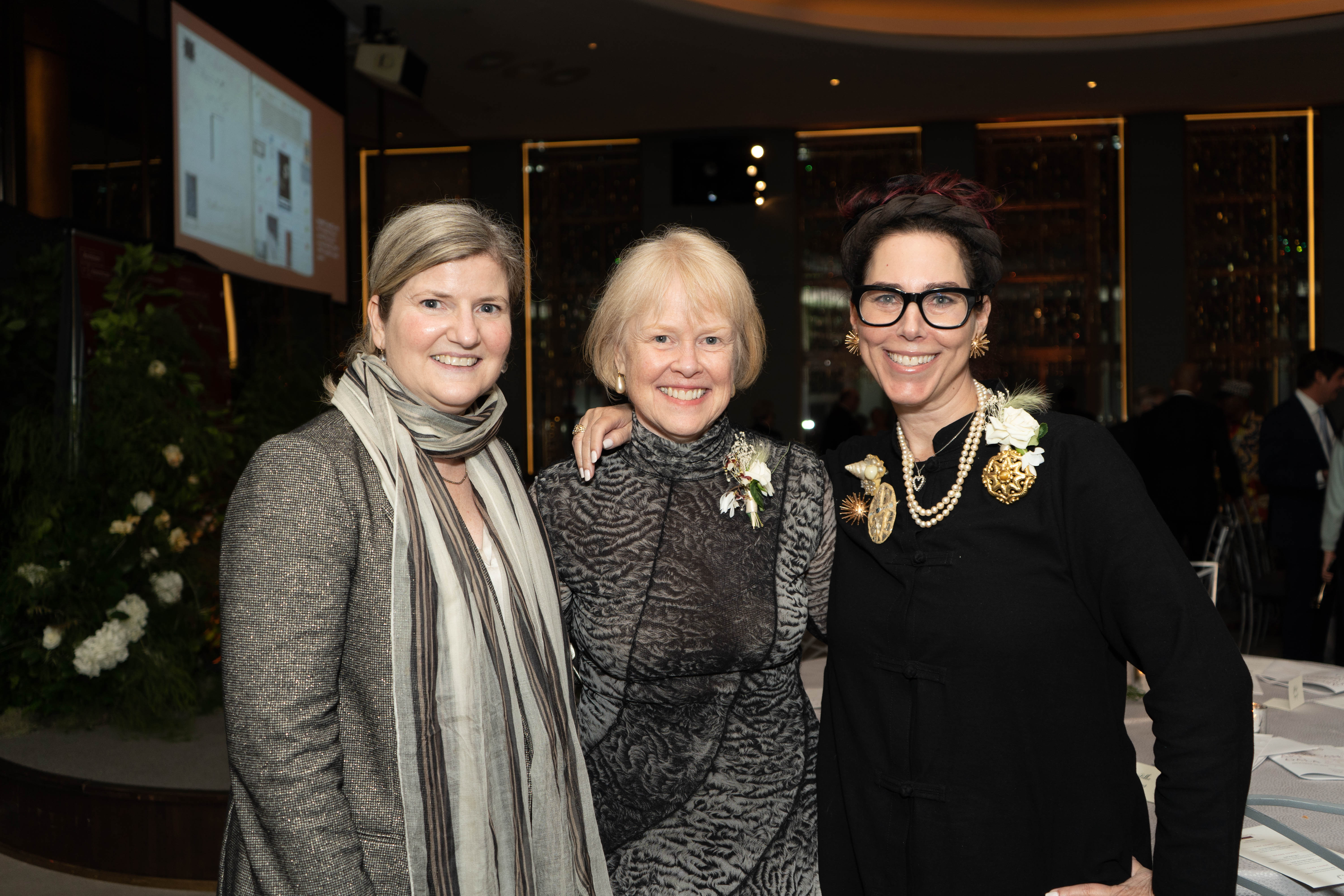 Amy Zinck, Liza Kirwin, and Amanda Quinn Olivar pose for a photograph during cocktail hour.
