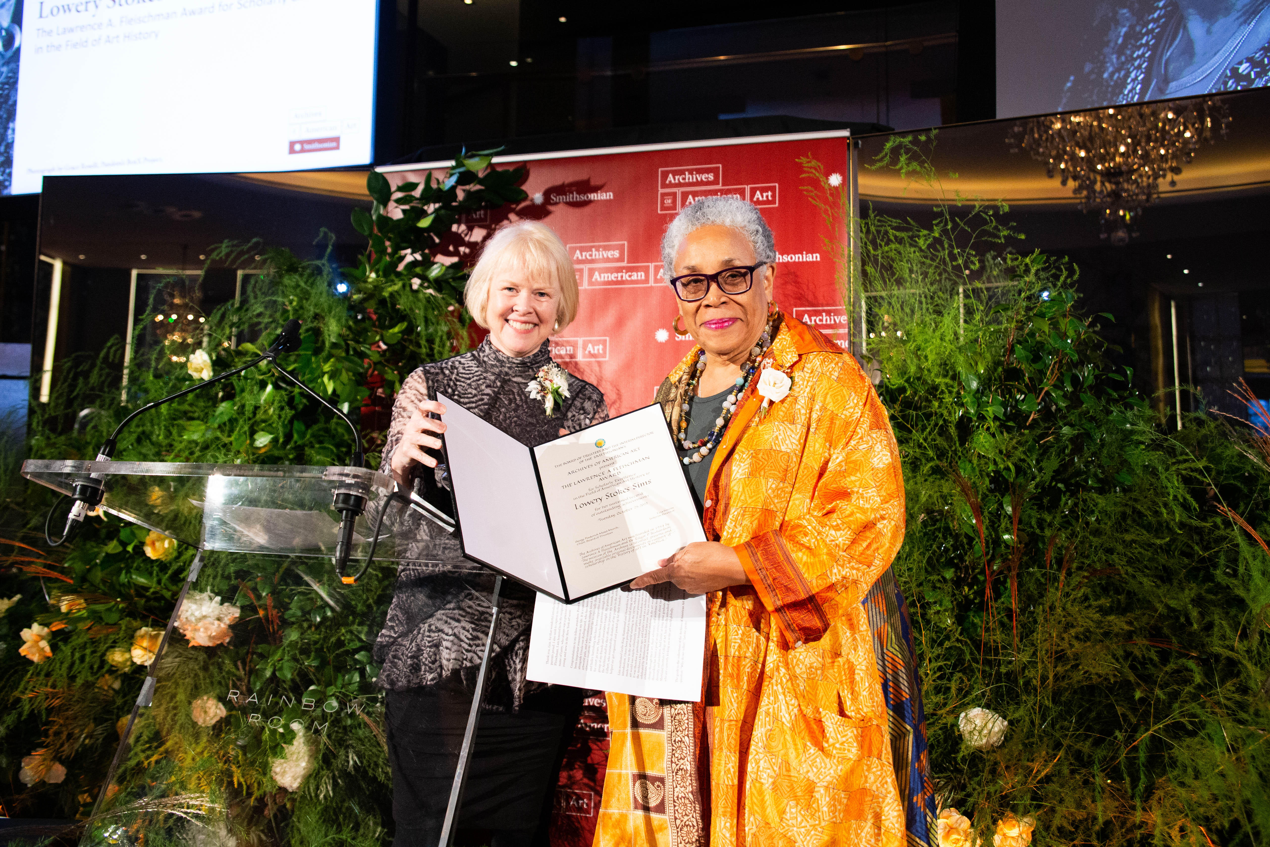 Liza Kirwin and Lowery Stokes Sims posing for a photograph after Lowery's acceptance of the Lawrence A. Fleischman Award for Scholarly Excellence in the Field of American Art History.