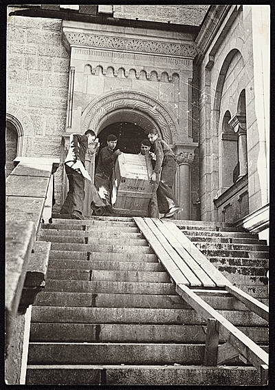 Four men carrying a crate of recovered artworks, previously looted by the  Nazis during World War II, down a staircase at Neuschwanstein Castle, 1945.  James J. Rorimer papers, Archives of American Art, Smithsonian Institution