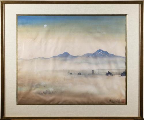 Watercolor scene of pale blue mountains with a full moon against a blue sky washed out by dust. The brown and beige dusty terrain has black buildings and a fence in the distance. The piece is in a linen matte with wooden frame with gold accents. 