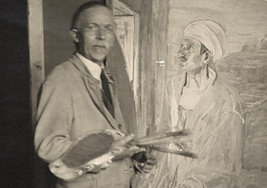 Henry Ossawa Tanner in his studio next to his painting, Judas.
