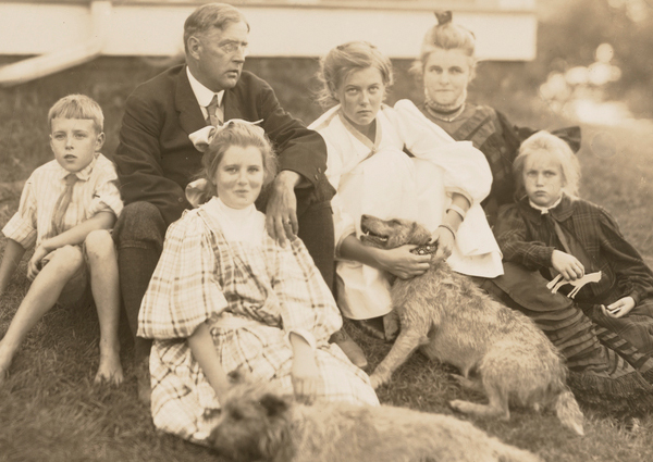 Edmund C. Tarbell and his family in front of their New Castle, New Hampshire home.