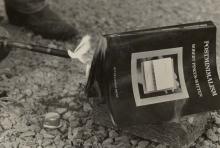 A copy of a book being burned with a blow torch.